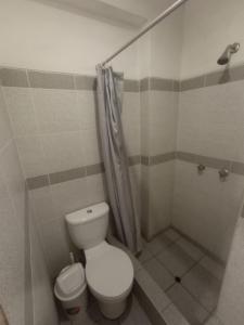 a bathroom with a toilet and a shower at HOSTAL PARIS in Piura