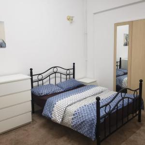 a bedroom with a bed and a dresser and a mirror at Monarch House in Manchester