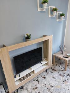 a wooden entertainment center with a flat screen tv at Casa vacanza Mamma Maria in Trecase
