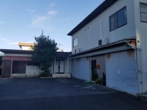a white building with a parking lot in front of it at Guest House Tatara - Vacation STAY 61943v in Yasugi