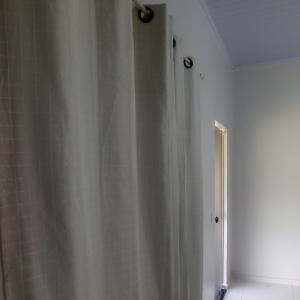 a bathroom with a shower with a shower curtain at Pousada Diadorim in Sao Domingos de Goias