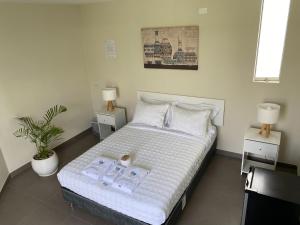 um quarto com uma cama com duas toalhas em Bungalow Jatun Mama em Ventanilla