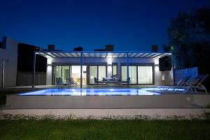 a swimming pool in a house at night at Averto Villas with private pool in Nydri