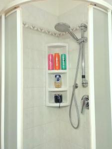 a bathroom with a shower with a camera on a shelf at Small Wave in Viareggio