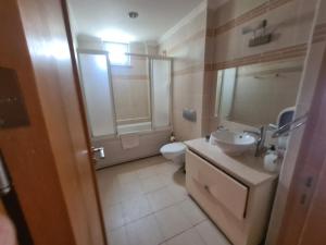 a bathroom with a sink and a toilet and a mirror at Alanya gold city villa in Alanya