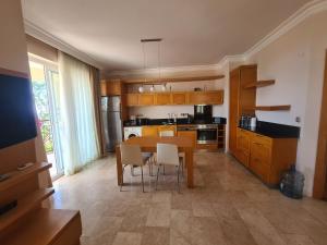 a kitchen with a table and chairs in a room at Alanya gold city villa in Alanya
