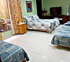 En eller flere senger på et rom på Pousada Girassol