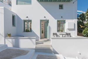 a white house with white walls and a patio at Anestorema House in Astypalaia