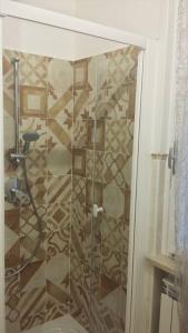 a shower with a glass door in a bathroom at La Casa di Paola in Cavaion Veronese