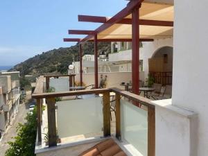 a balcony with a table and chairs on a building at Kissandros Hotel in Agia Galini