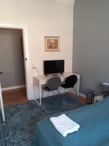 a bedroom with a desk with a computer and two chairs at Rent a Room Copenhagen in Copenhagen +22 photos