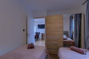 a hotel room with two beds and a mirror at Vila Podkalac in Žrnovo