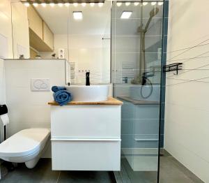 a bathroom with a sink and a shower at FEEL HOME DeLuxe CORVIN -FREE PARKING-AC-Elevator in Budapest