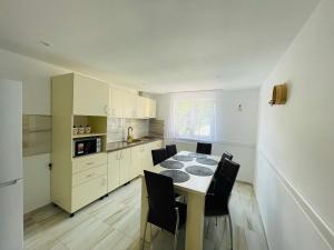 a kitchen with a table and chairs in a room at Pensiunea Sport in Buşteni