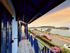 a blue balcony with a view of the water at La Goleta - 6915 in Noja