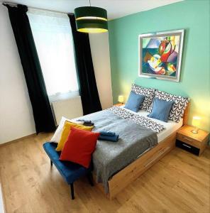 a bedroom with a bed and a chair in it at Feel Home DeLuxe CORVIN # FREE PARKING # AC # Elevator in Budapest