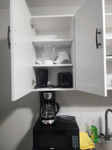 a kitchen counter with a blender in a cupboard at Modern Apartment London Ontario in London