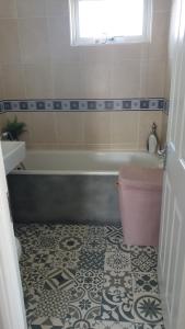 a bathroom with a tub and a toilet and a sink at 2 bed lodge sleeps 6 in Rhyl