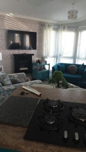 a living room with a stove and a couch at 2 bed lodge sleeps 6 in Rhyl