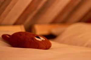 a teddy bear laying on top of a bed at La Reserve in Brugelette