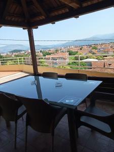 a blue table and chairs on a balcony with a view at Apartments Šofranac in Podgorica