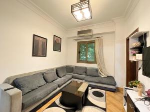 a living room with a couch and a table at Apt in The Heart of Zamalek in Cairo