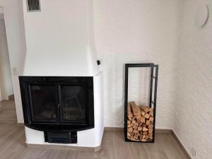 a fireplace in a room with a pile of wood at Rustico Campei in Medeglia