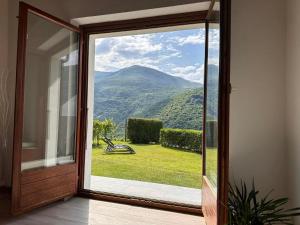 a sliding glass door with a view of a mountain at Rustico Campei in Medeglia