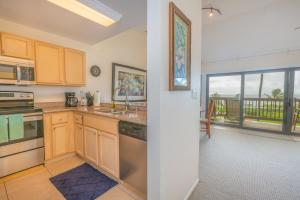 a kitchen with a sink and a large window at Oceanfront 1 BR Condo at Kaha Lani KL309 in Kapaa