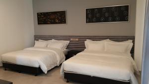 Postel nebo postele na pokoji v ubytování M Design Hotel @ Shamelin Perkasa