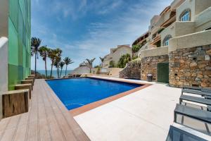 a swimming pool in the backyard of a house at Villas Coral Huatulco in Santa Cruz Huatulco