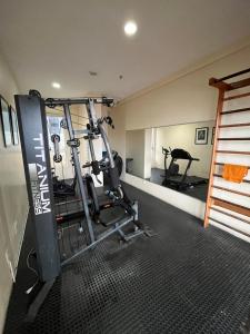 a room with a gym with two tread machines at American Flat in São Luís