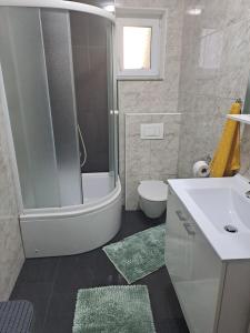 a bathroom with a tub and a sink and a toilet at Apartment Mira in Šibenik