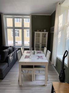 a living room with a white table and chairs at 1St Floor Oasis - Parking/WiFi in Stavanger
