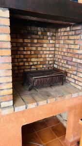 a brick fireplace with a bench in it at VILLA CAU B&B - Les Anglores in Claviers