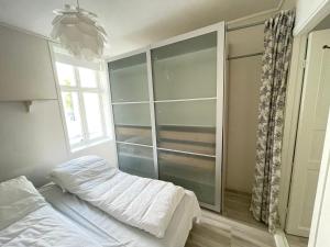 a bedroom with a bed and a large glass closet at 1St Floor Oasis - Parking/WiFi in Stavanger