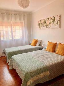 two beds sitting next to each other in a room at Retorta do Pico - Alojamento Local in Caminha