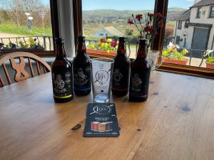 a group of three bottles of beer sitting on a table at Y Llew Coch in Conwy