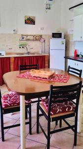 a kitchen with a table with a pizza on it at Il Principe casa vacanze in Trabia