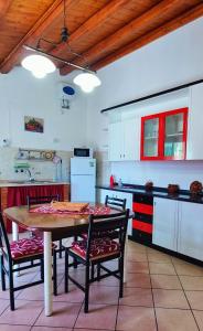 a kitchen with a table and chairs in a room at Il Principe casa vacanze in Trabia