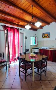 a kitchen with a table and chairs in a room at Il Principe casa vacanze in Trabia