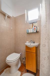 a bathroom with a toilet and a sink at LiliHome in Gárdony