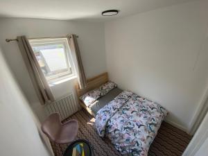 a small room with a bed and a window at Nottingham Home Stay in Nottingham