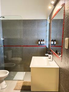 a bathroom with a sink and a toilet and a mirror at Casa Vergara I in Villa Unión