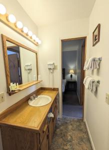 a bathroom with a sink and a mirror at Western Riviera Lakeside Lodging in Grand Lake