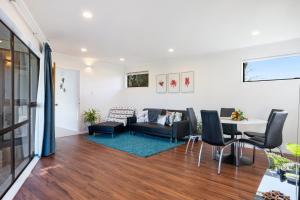 a living room with a couch and a table at Seaside Sensation - Te Horo Beach Holiday Home in Te Horo