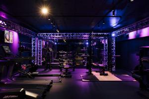 a gym with purple lights and weights at Pullman Melbourne City Centre in Melbourne