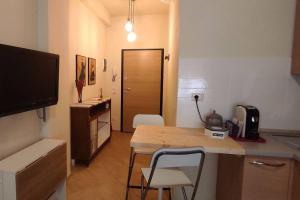斯坎迪奇的住宿－La Casetta tra Chianti e Firenze，厨房配有桌子和带2把椅子的柜台。