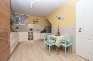 a kitchen with a table and chairs in a room at House Katarina in Krvavica