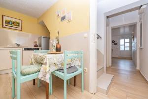 a kitchen and dining room with a table and chairs at House Katarina in Krvavica